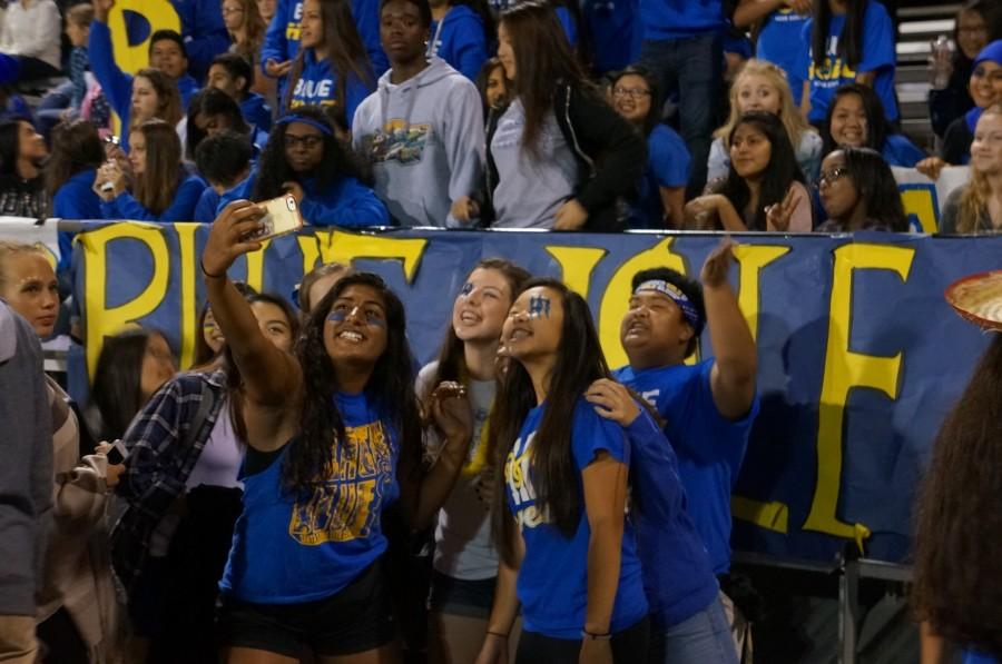 Juniors Justin Barbero and Alexie Sass take a selfie with sophomores Minhaal Naeem and Kaitlyn Lam in front of the Blue Hole section. 
