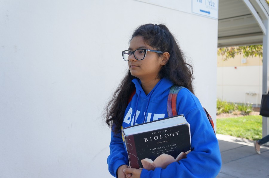 Senior+Saira+Singh+carries+her+old+AP+Biology+textbook+to+class+daily.+