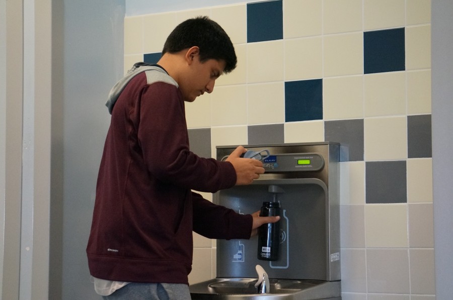 Freshman Ricky Austin fills his water bottle.