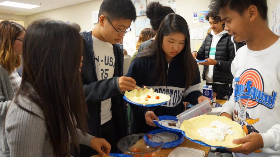 Students enjoy crepes at a French Club meeting.