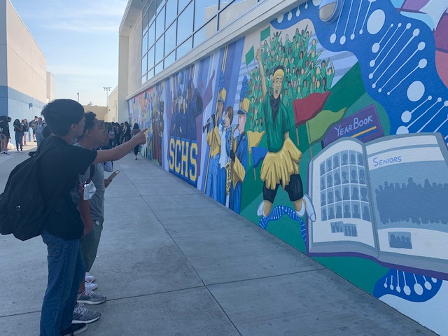 Freshmen Brandon Roque and Valentino Aguilar admire the mural. 