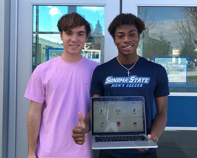 Arthur Tallet (left) and Tamba Mattia (right) pose with the online version of their app. 