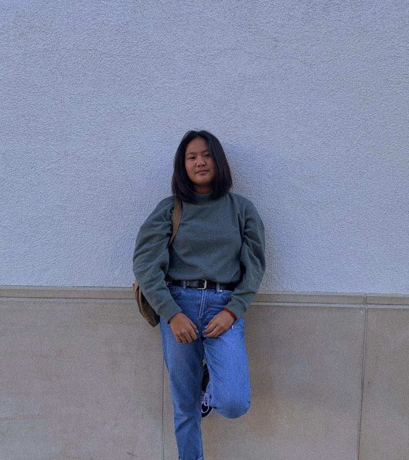 Freshman Janna Andaya wears a crewneck sweater and high-waisted pants, pulling styles from the 1990s. 