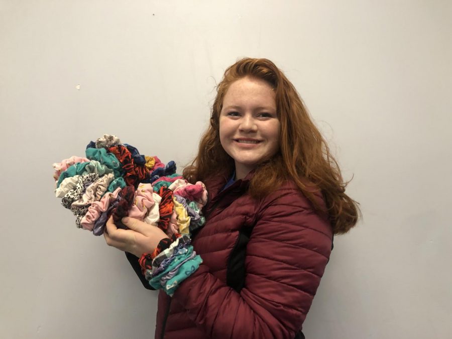 Romard poses with her scrunchies. The products come in various colors and styles. 