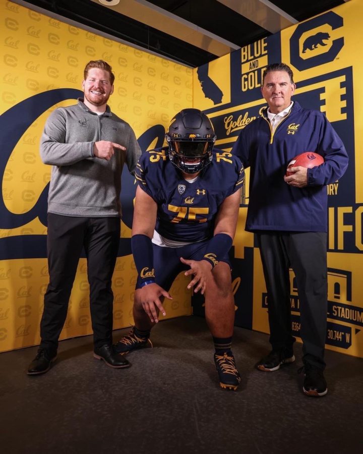 Junior Amos Talalele (center) poses with Cal football coaches Angus McClure (right) and Michael Saffell (left).