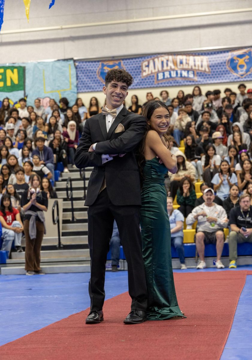 Seniors Asher Dubin and Cheyenne De Guzman pose for a picture after walking out during the homecoming rally court ceremony. 