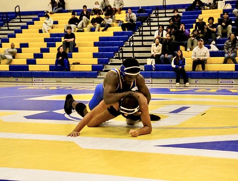 Kai Johnson takes advantage of early practices in order to better
his techniques, allowing him to succeed on the wrestling mat.