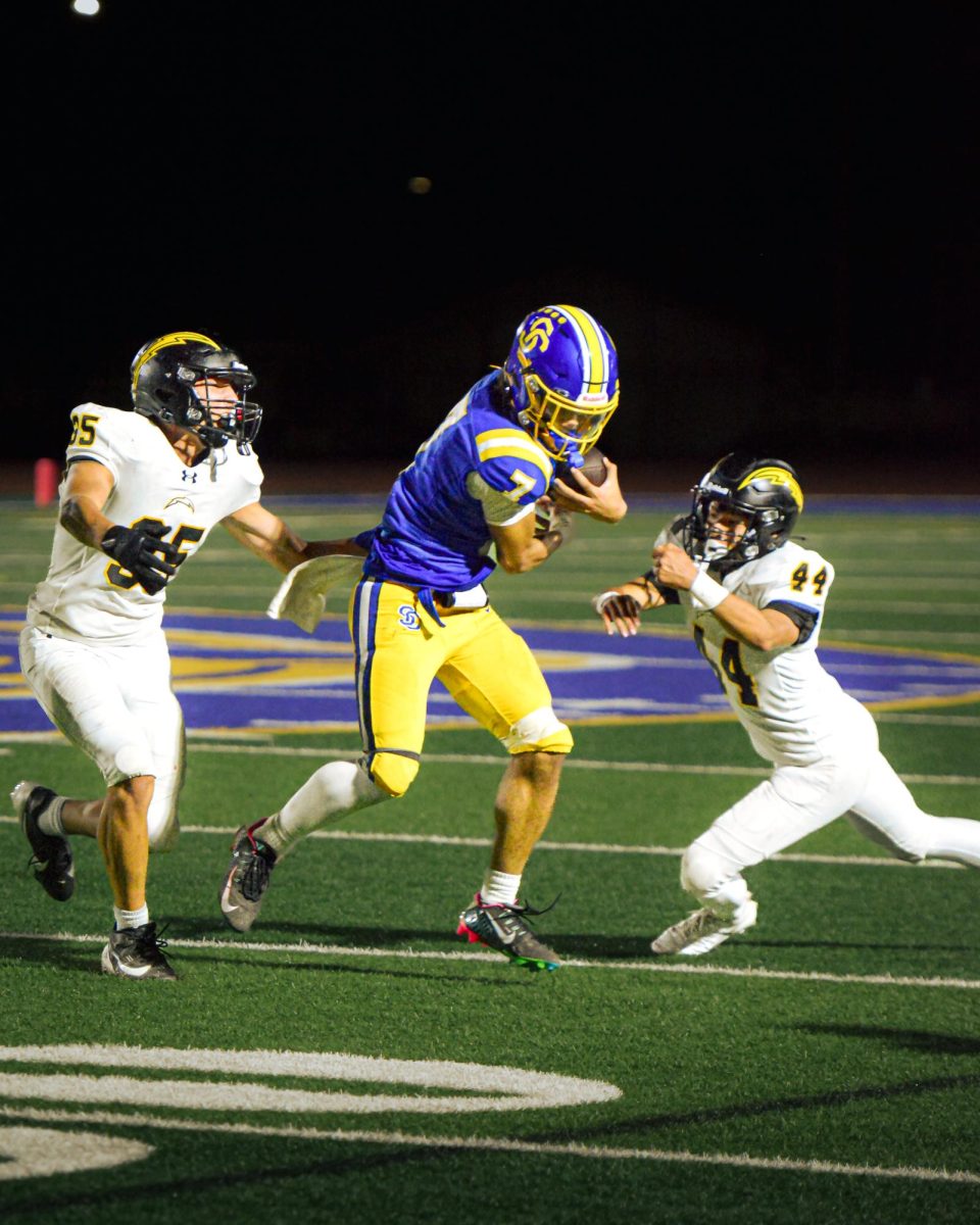 Senior Tayshawn Reed runs between two Wilcox defenders at Santa Clara High School on Sep. 26, 2024.