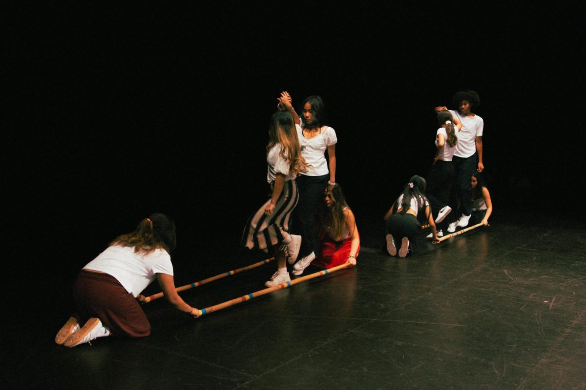 Senior Andrea Zyrene Palisoc performs tinikling, a traditional Filipino dance, in the SCHS theater during the annual FASA presentation on Monday Oct. 7, 2024.