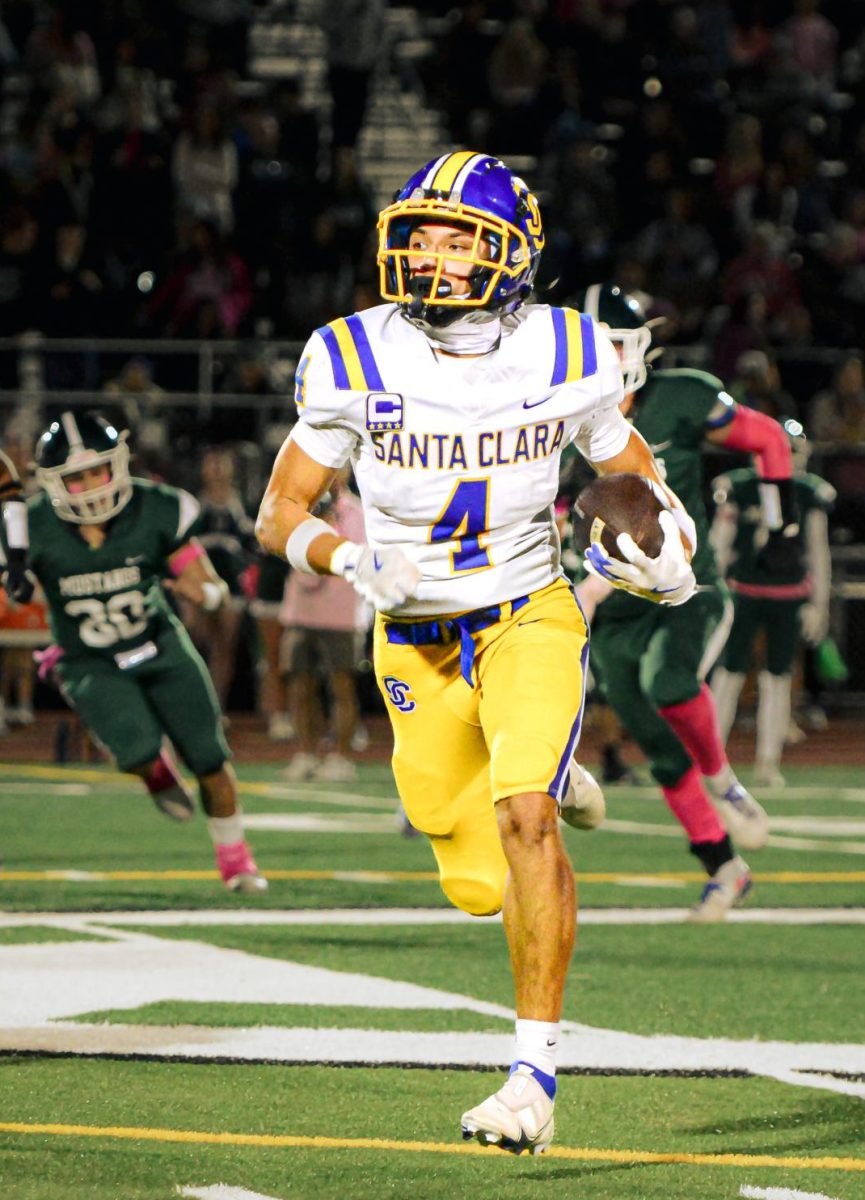 Senior Gabriel Chavez runs the ball off a sweep play.