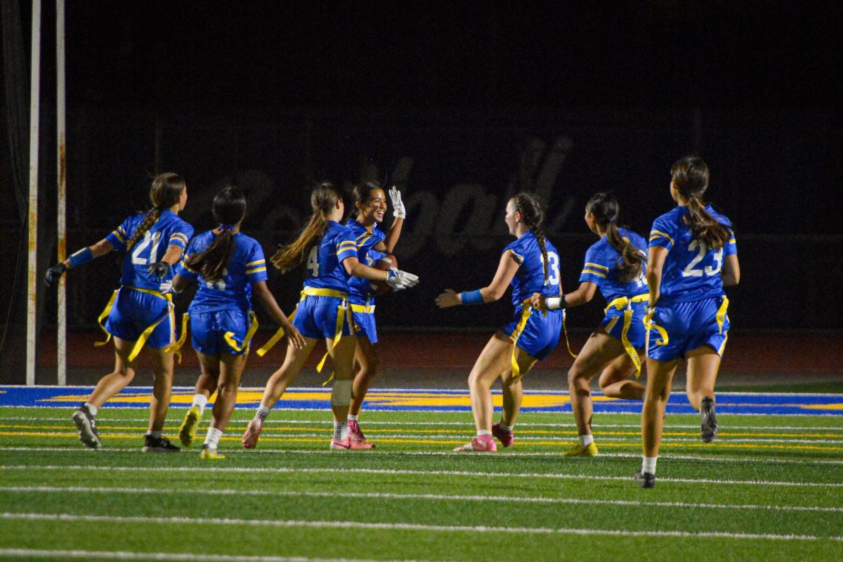 SCHS's girls varsity flag football team celebrates after a pick-six play against Wilcox High School at a home game in their inaugural season this year.