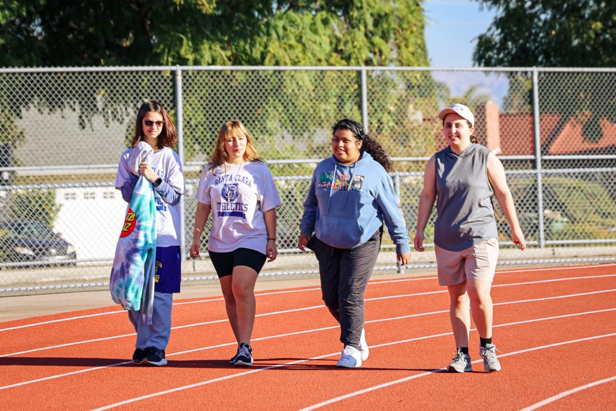 Senior Aleeana Salazar completes the daily warm ups with her special education classmates.