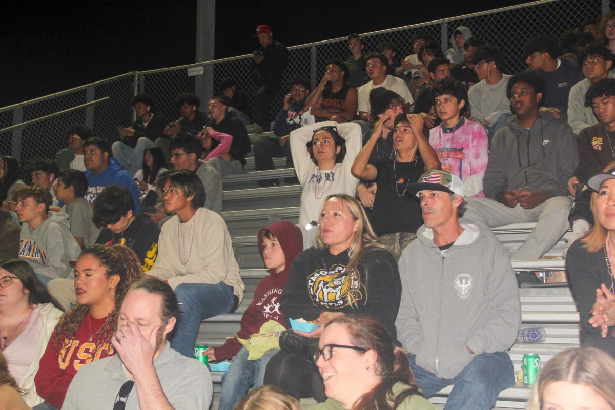 On Thursday, Oct. 9, 2025, students of all grades gather with friends to socialize and watch the football game from the stands.