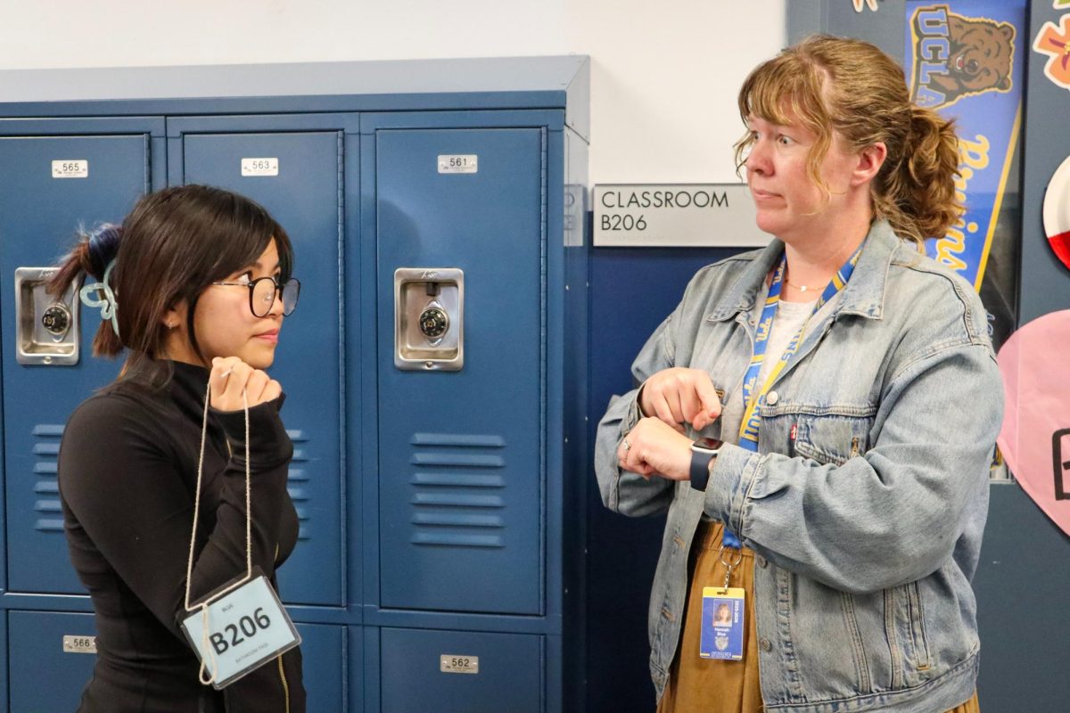 English teacher Hannah Blue (right) encourages sophomore Vanessa Dinh (left) to prioritize her education and class time.