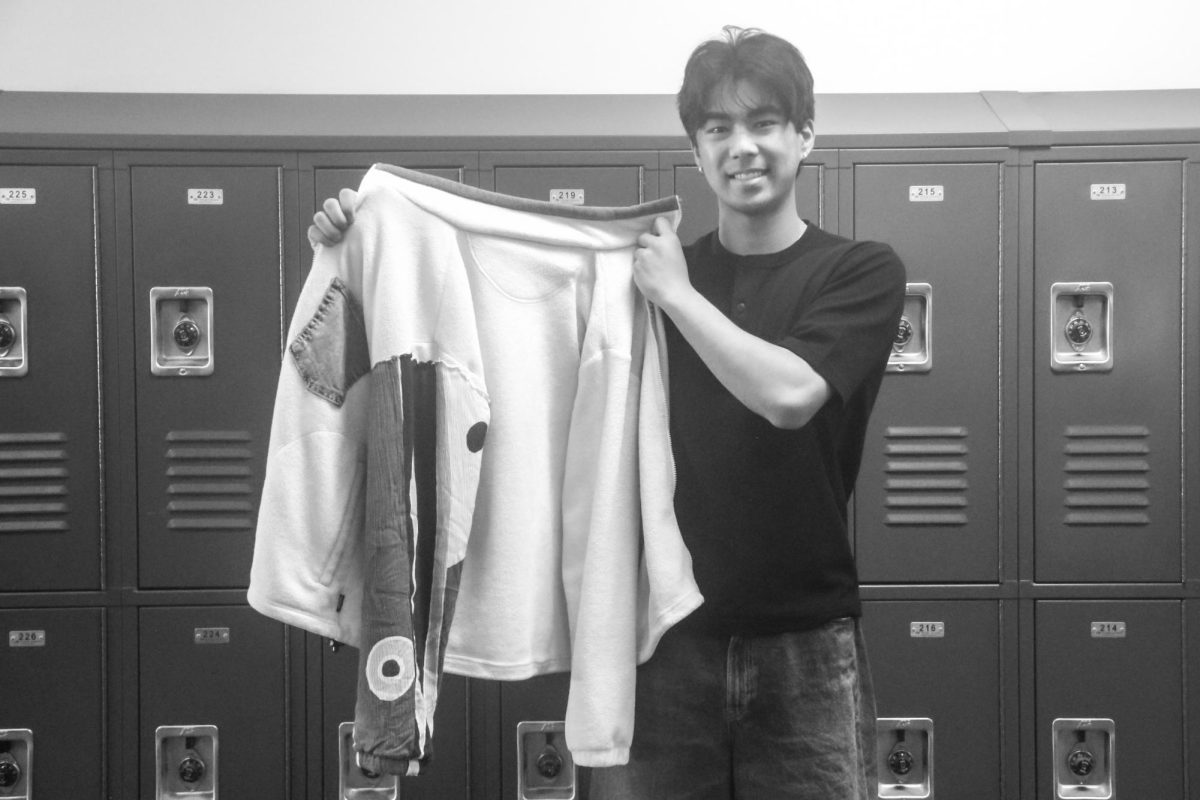 Through custom clothes like the jacket he holds, junior Kainoa Wong finds that DIY-ing allows him to better express himself.